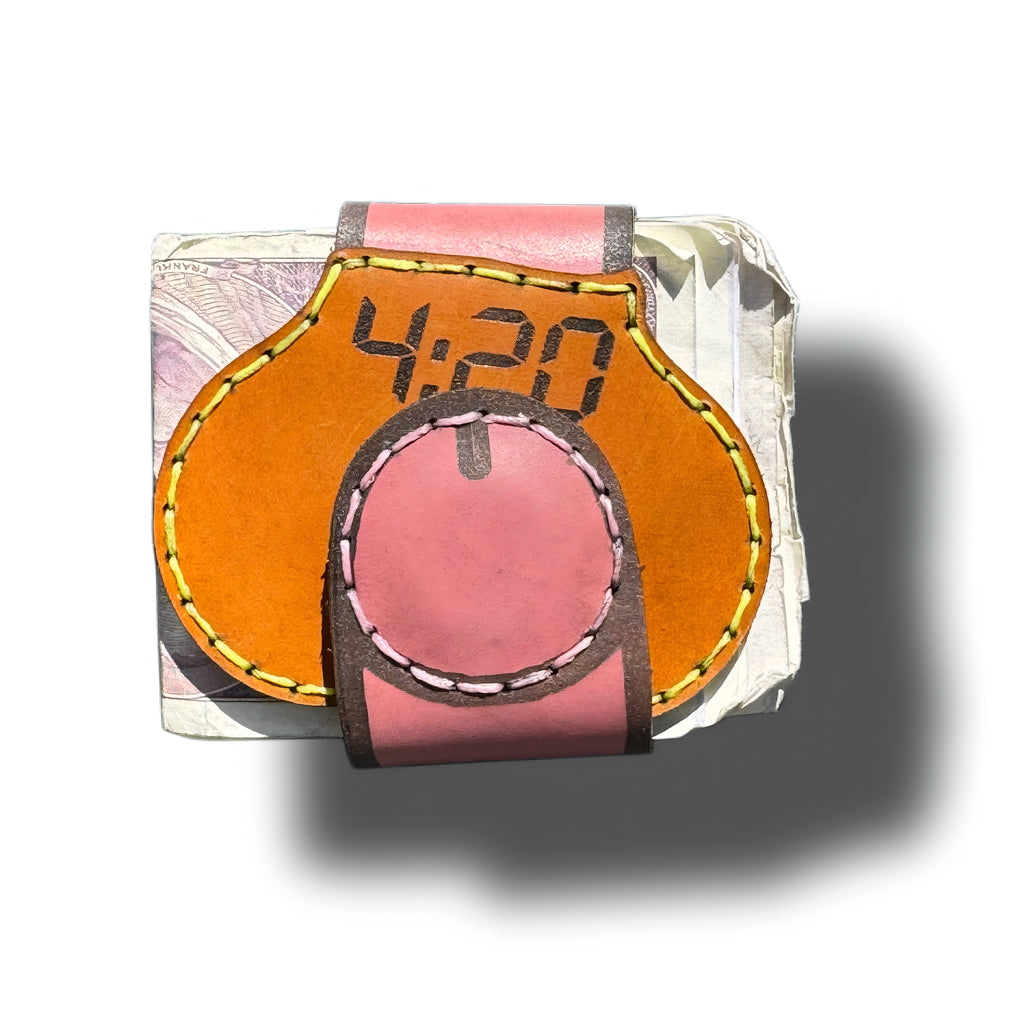 4:20 engraved leather money clip closed, pink magnetic strap wrapped over the tan front