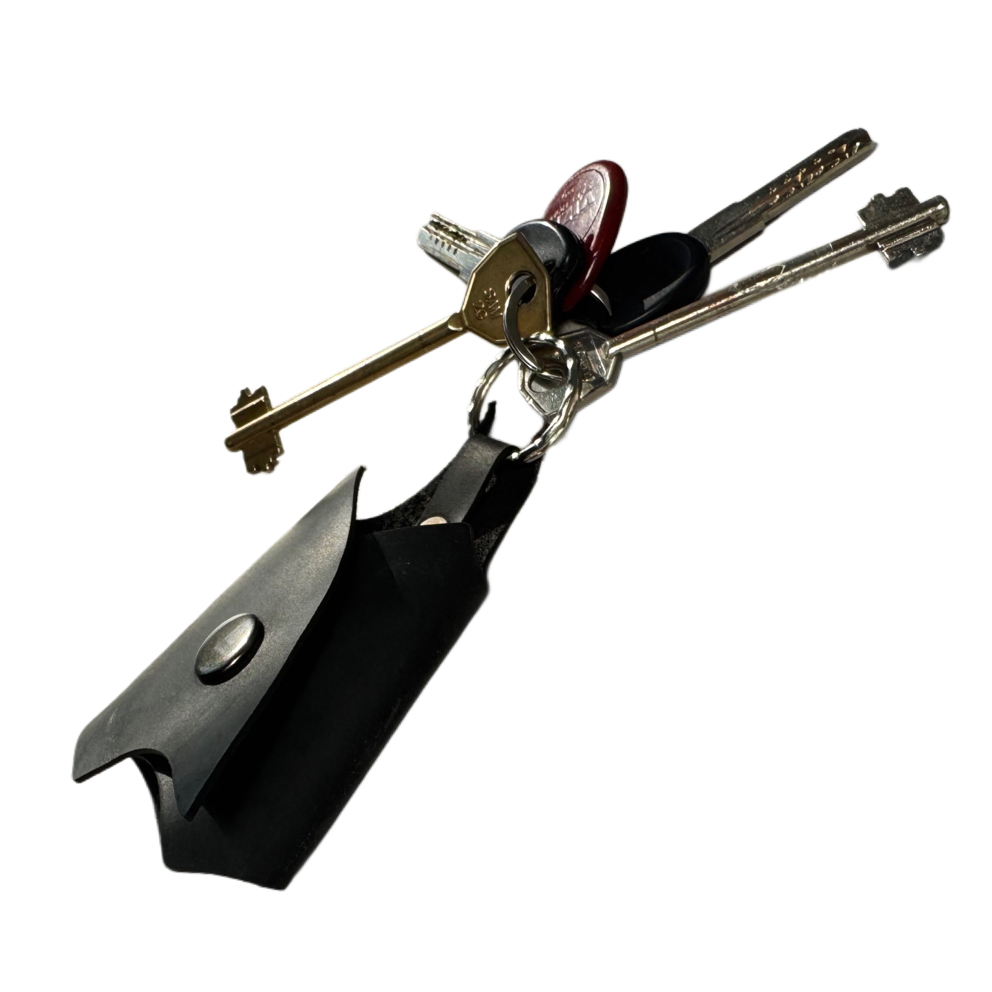 Handcrafted leather key holder with engraved design — in-hand view — Lamamarka