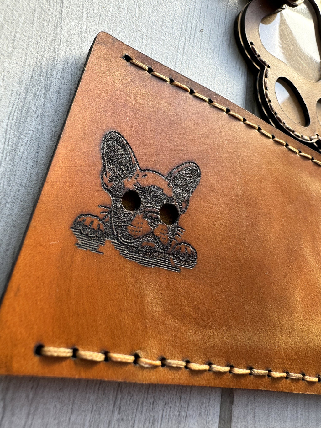 Leather paw print pet memorial keychain keepsake — in-hand view — Lamamarka