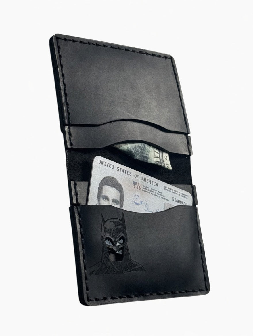 Slim black leather bat ID wallet with an ID card in the window slot and embossed bat hero mask detail