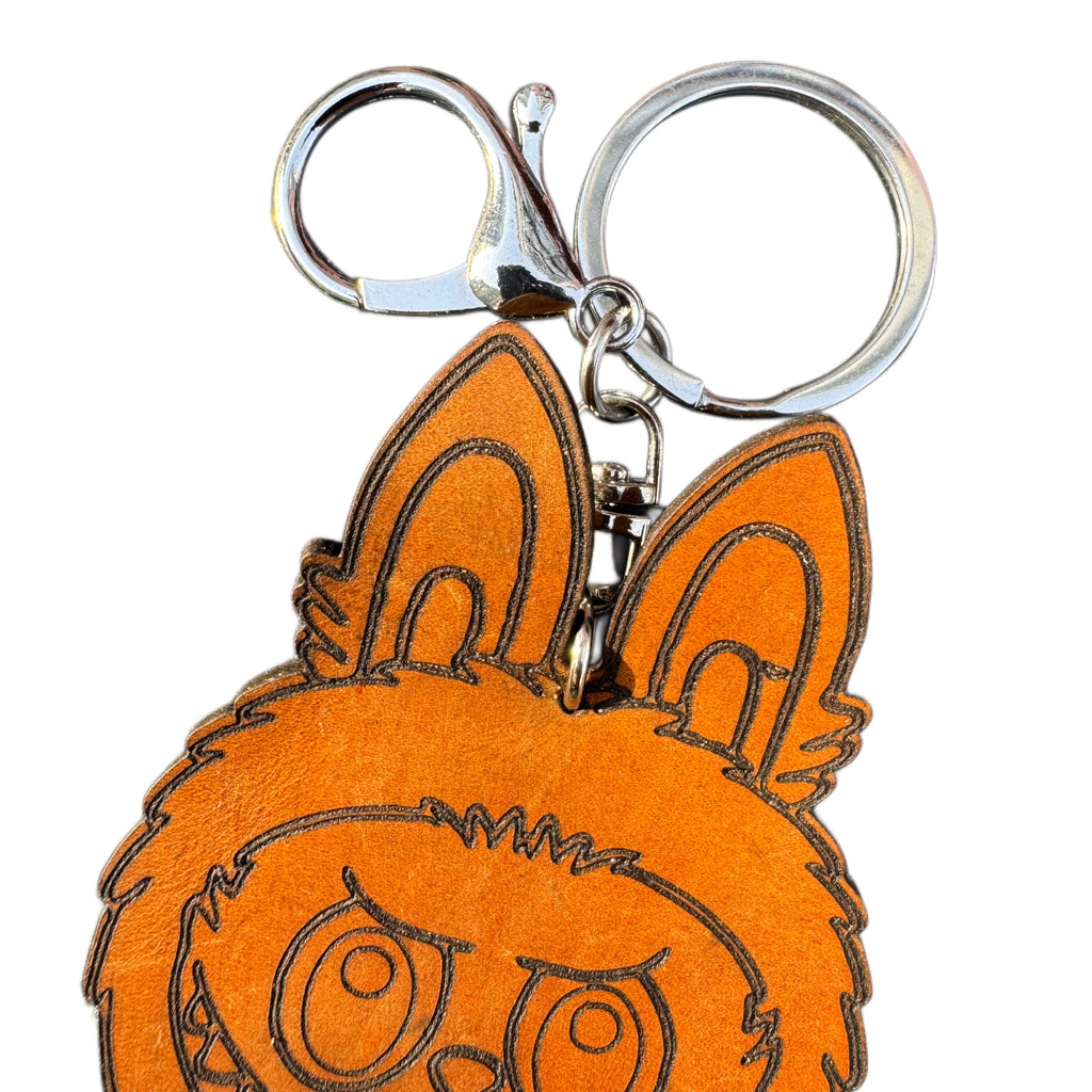 Handcrafted leather character keychain — in-hand view — Lamamarka