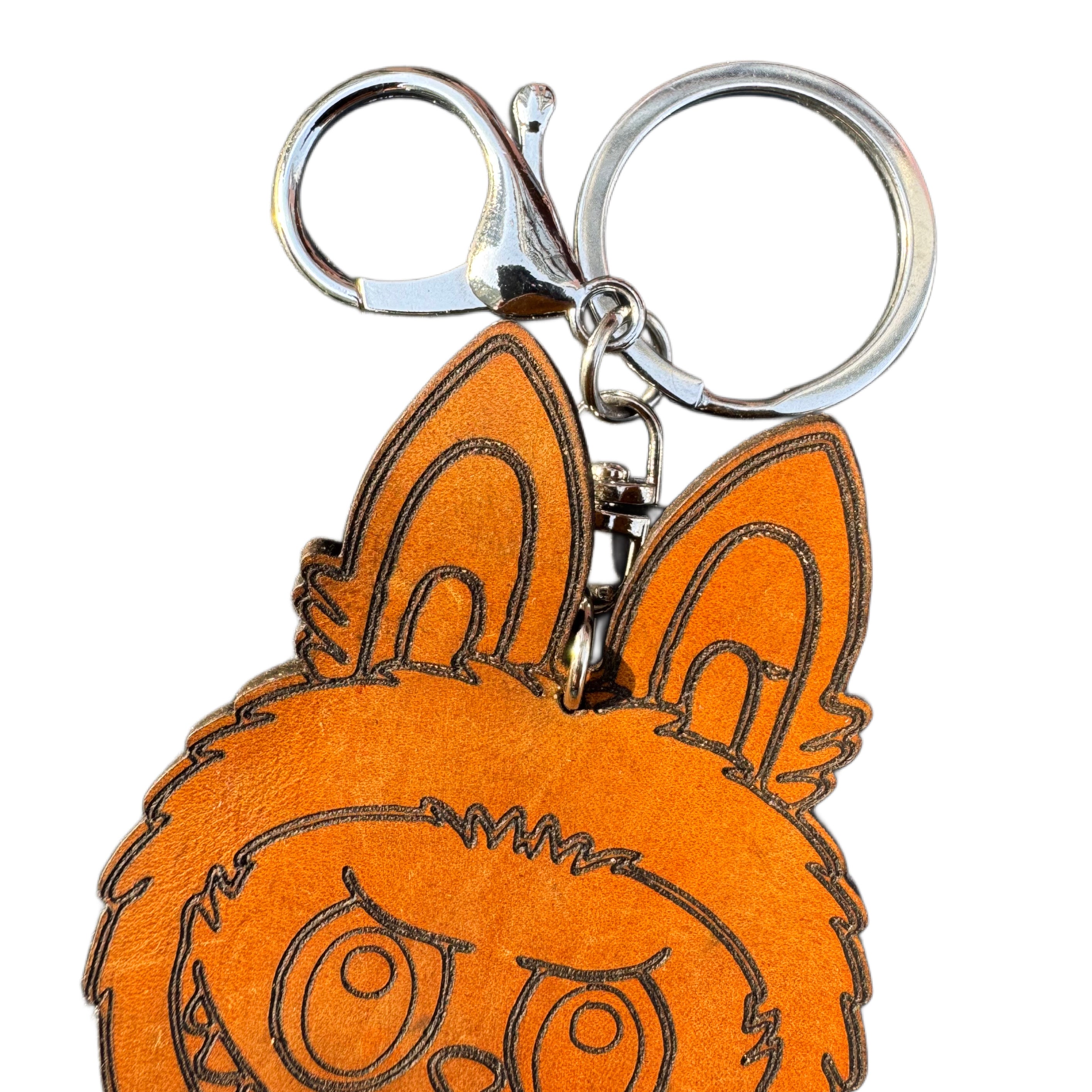 Handcrafted leather character keychain — in-hand view — Lamamarka
