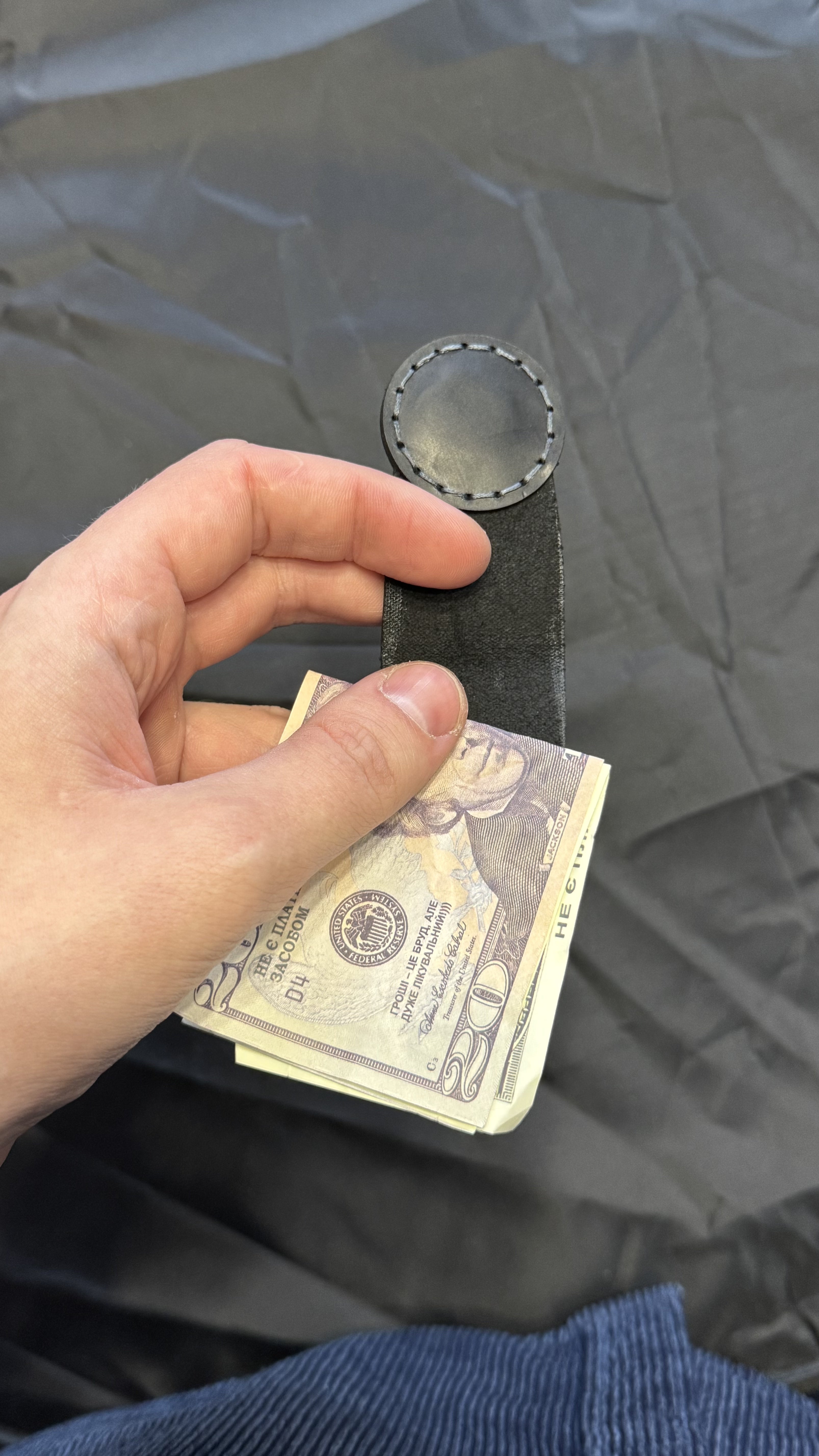 Black leather magnetic money clip, minimalist EDC — close-up — Lamamarka