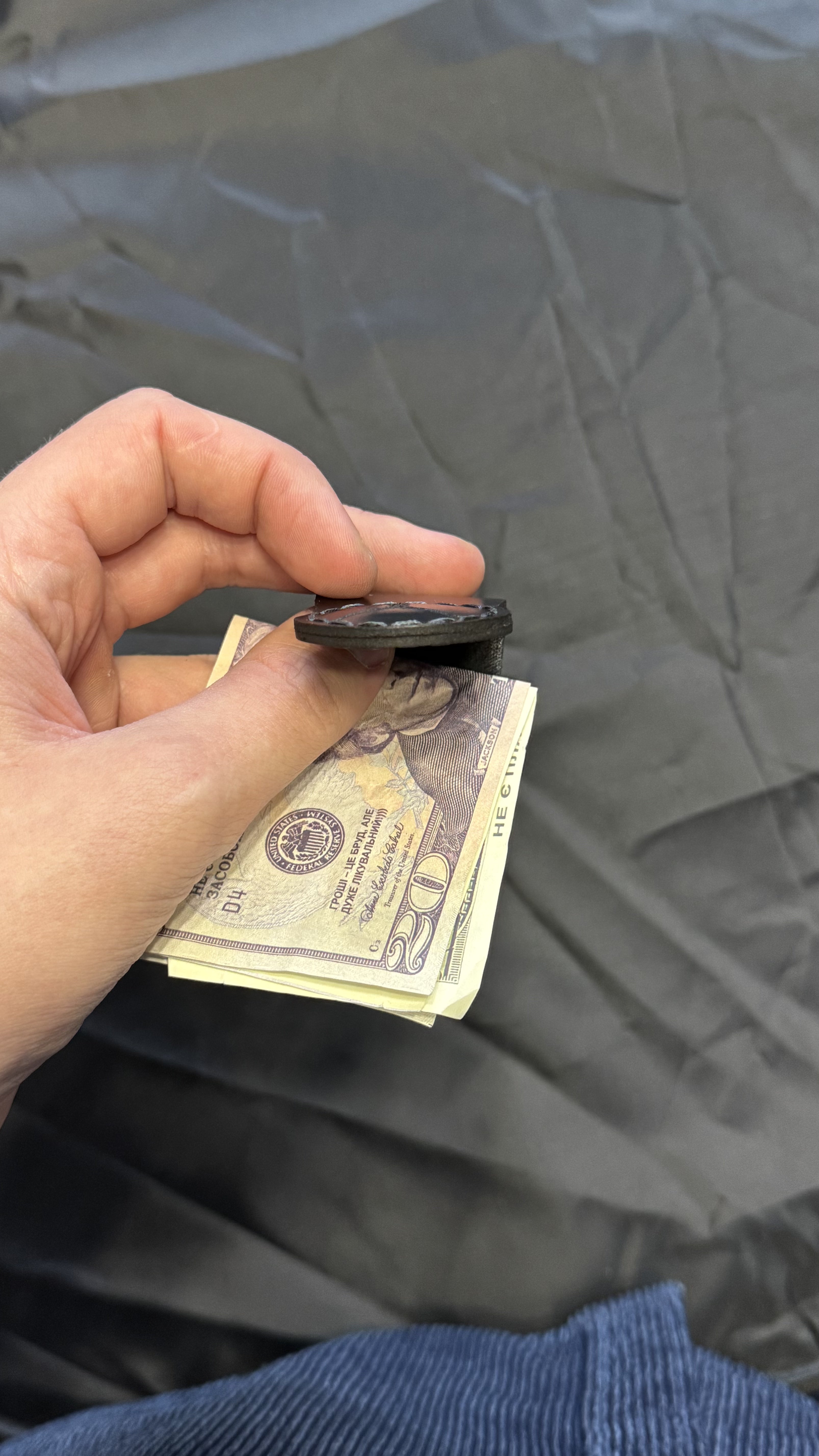 Black leather magnetic money clip, minimalist EDC — lifestyle view — Lamamarka