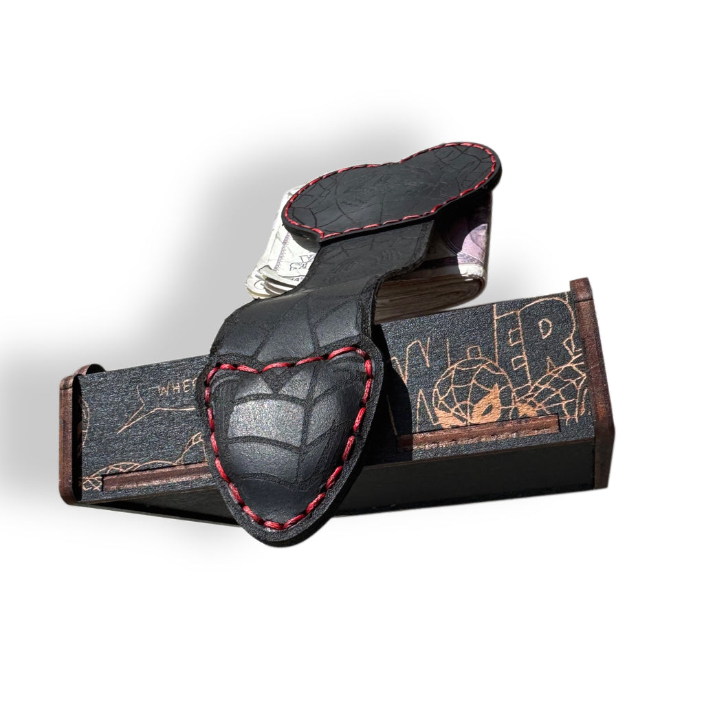 Black leather XL money clip tooled with spider webs, shown full length with cash