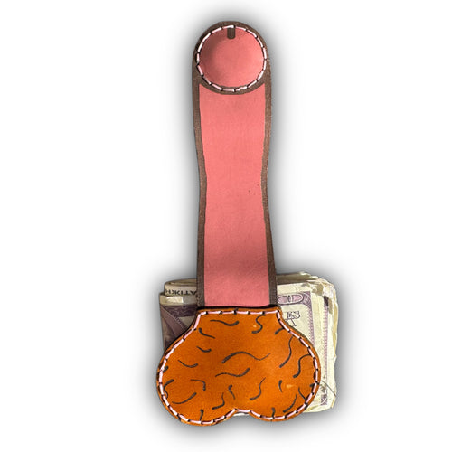 Au naturel XL leather money clip fully extended, long pink strap with a round magnetic tip above the tan pouch on folded cash