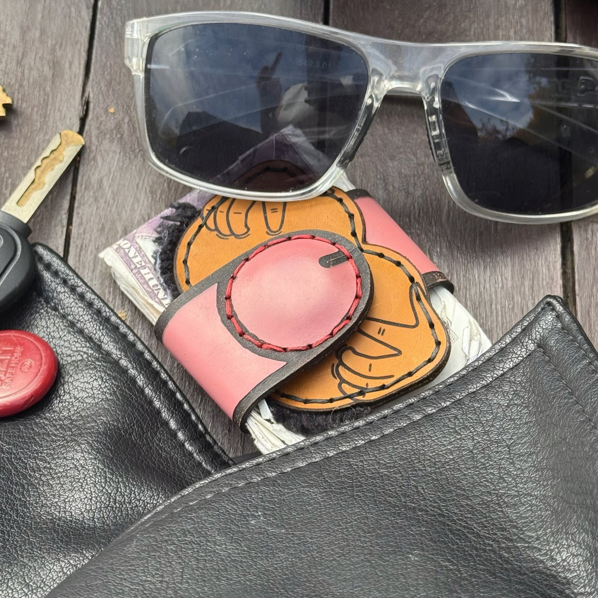 Black hole XL leather money clip on folded cash with sunglasses and keys, everyday carry