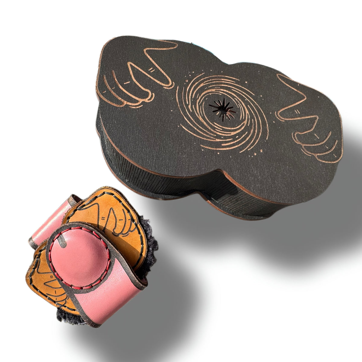 Black Hole wooden gift box closed beside a cheeky leather money clip for scale