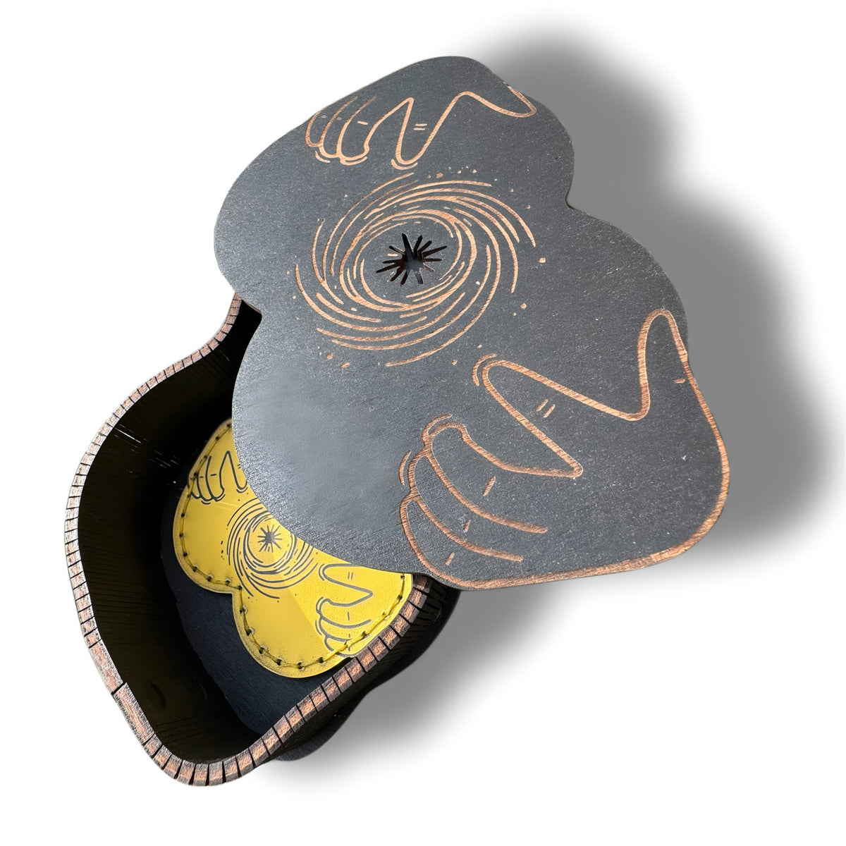Butt shaped wooden gift box open, engraved black hole lid and yellow money clip inside