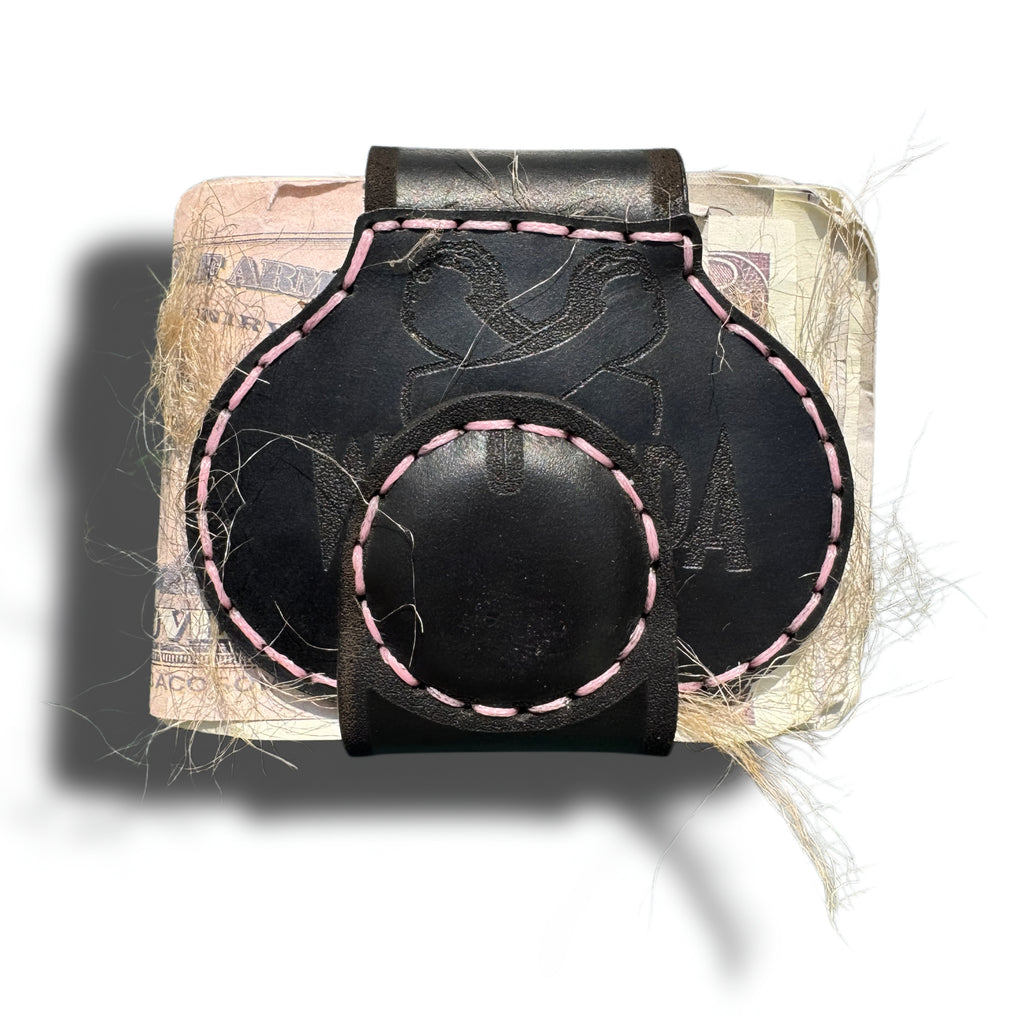 Close-up of magnetic snap on black leather XL cheeky money clip, pink stitching