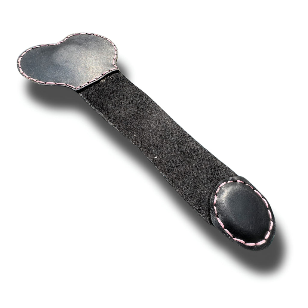 Handmade black leather money clip opened flat, pink stitched edges and suede back