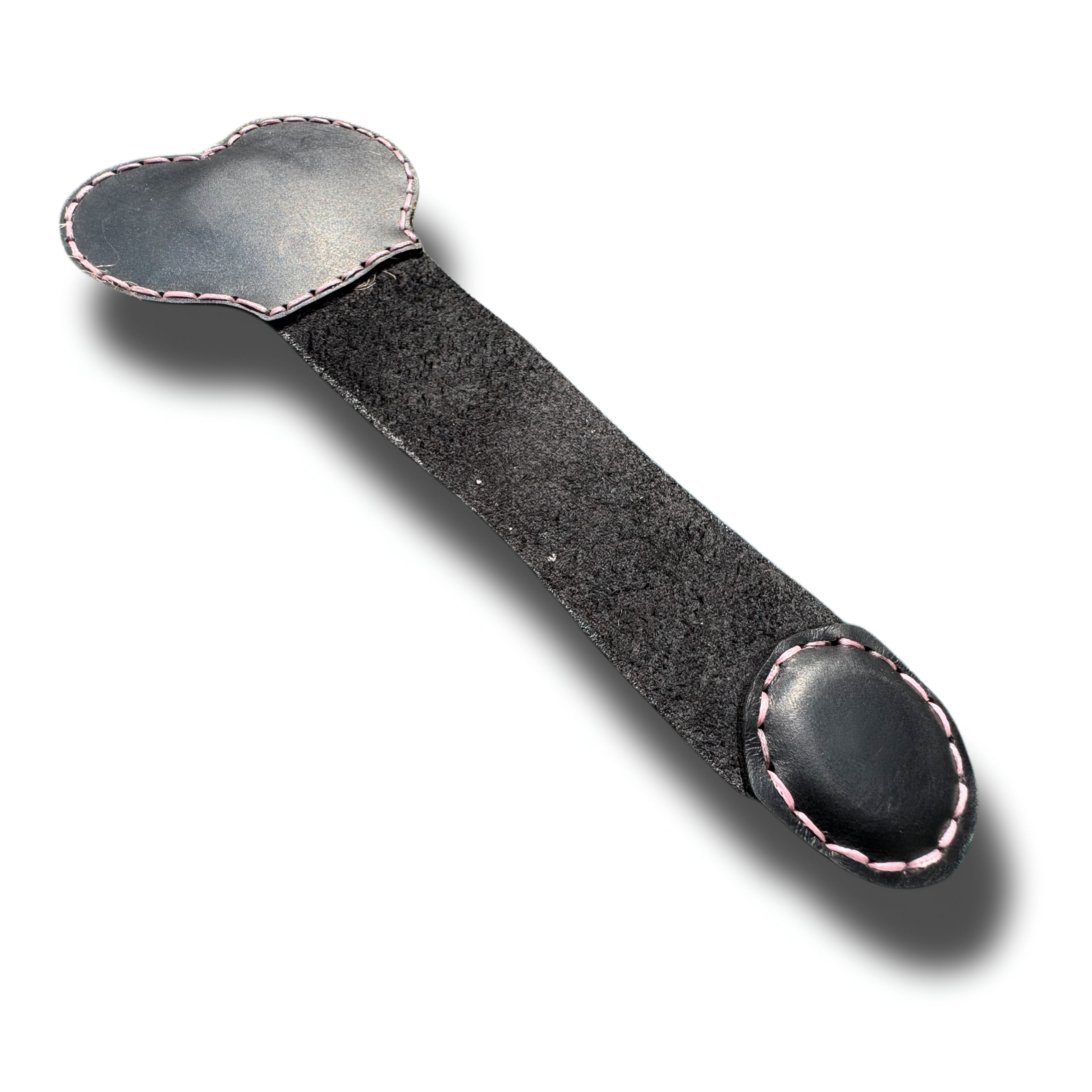 Handmade black leather money clip opened flat, pink stitched edges and suede back