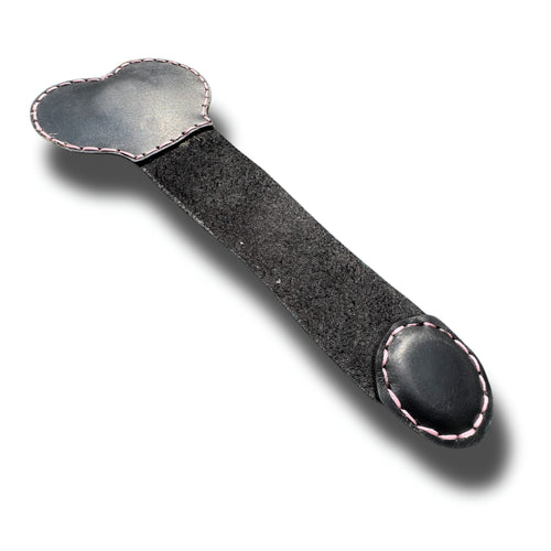 Handmade black leather money clip opened flat, pink stitched edges and suede back