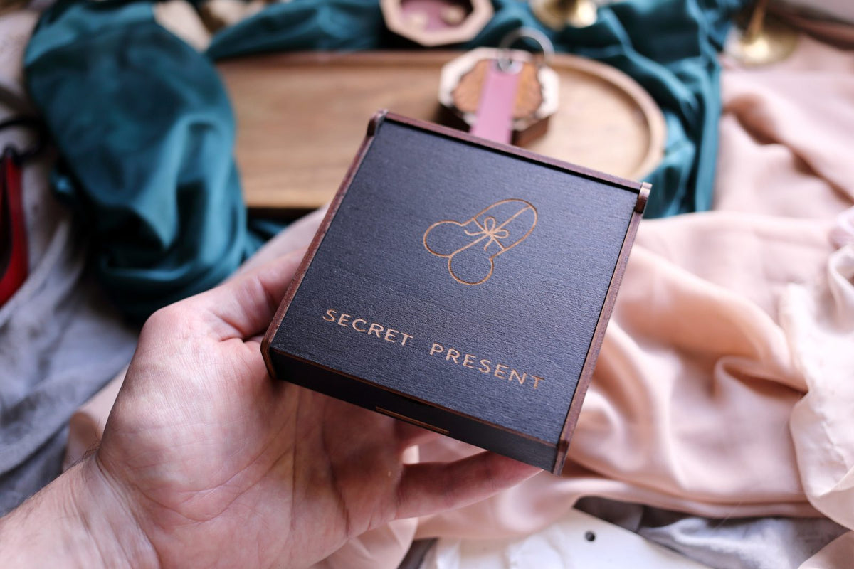 Hand holding a handcrafted Lamamarka wooden gift box engraved Secret Present