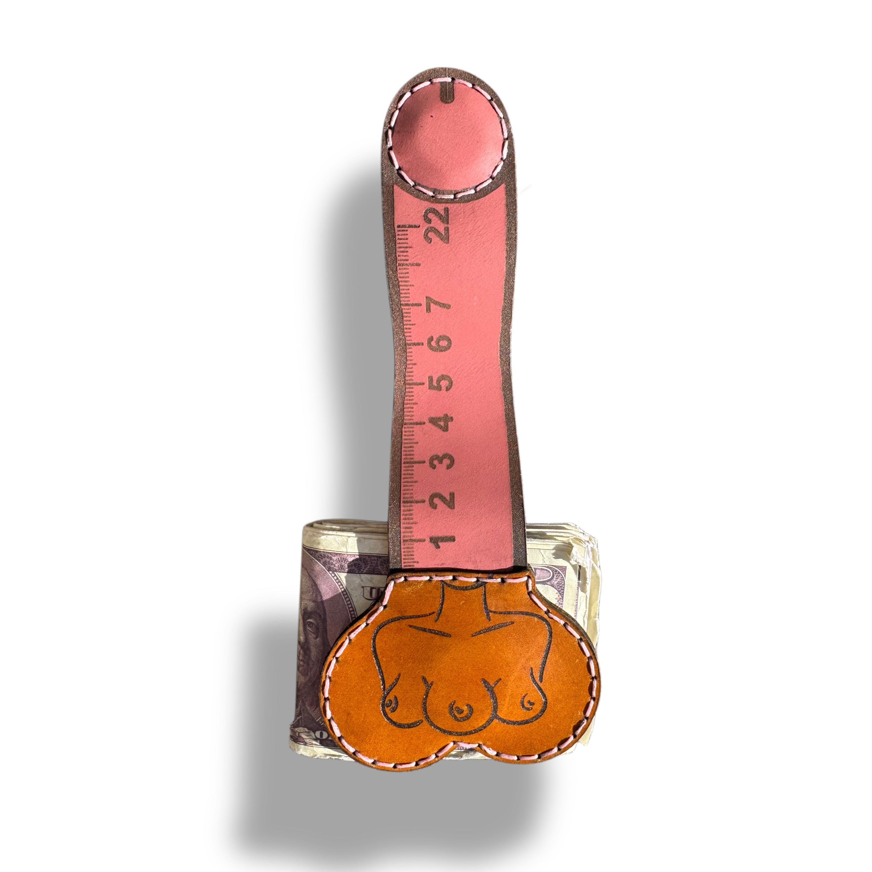 Ruler edition XL leather money clip fully extended, pink strap marked with inch numbers above a tan pouch clamped on folded cash