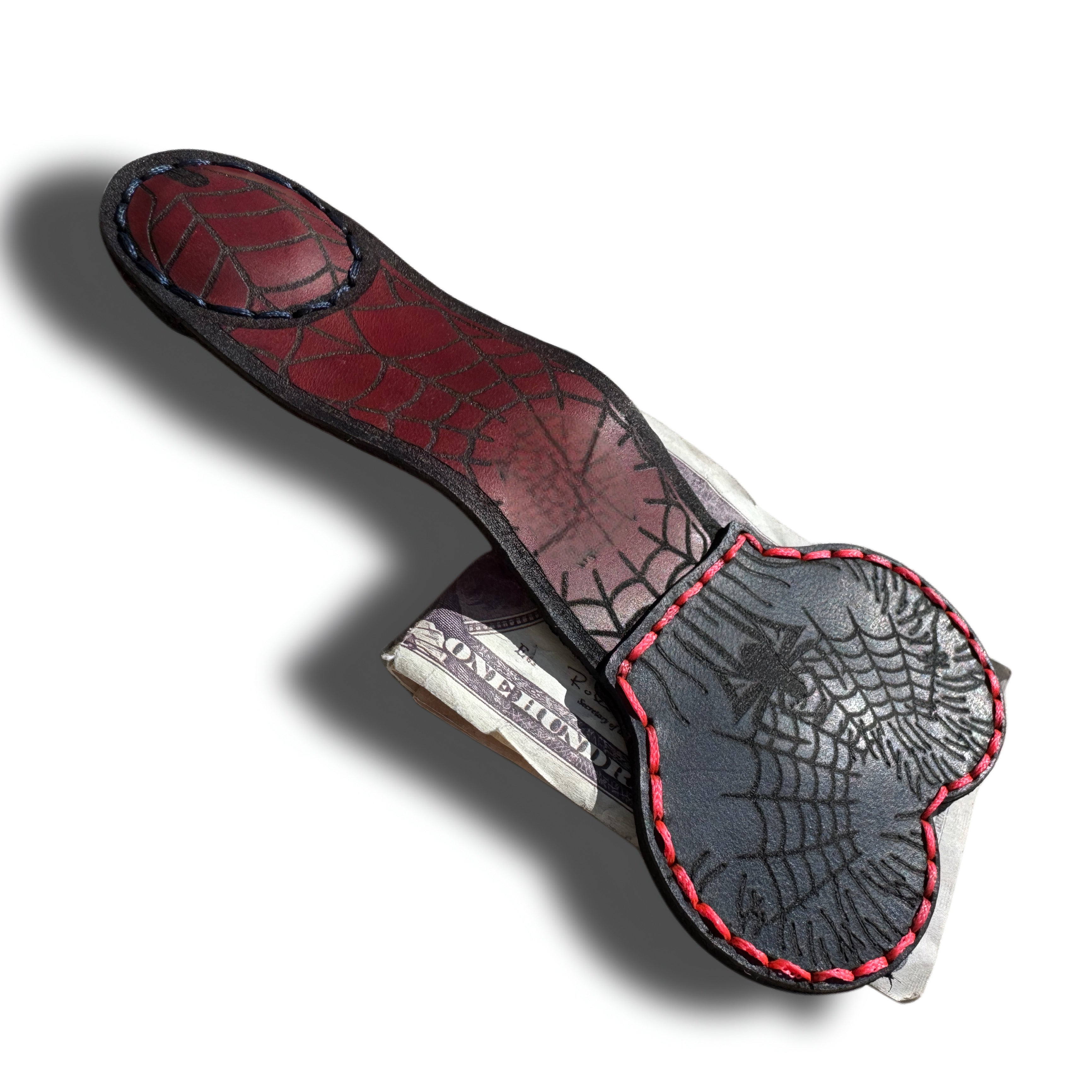 Spider web leather money clip open, showing the magnetic clip and engraved webs on both sides - Lamamarka
