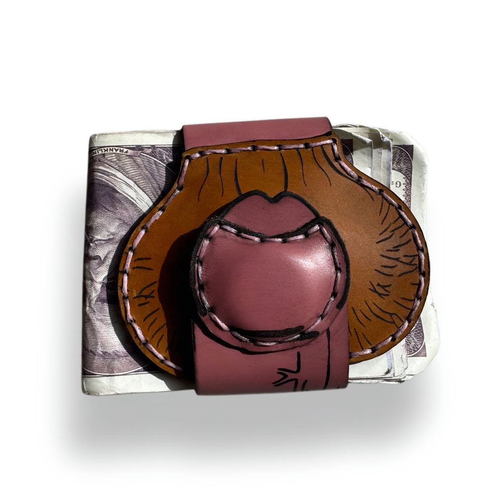 Uncut edition XL leather money clip folded over a stack of cash, two-tone tan and pink with hand stitching