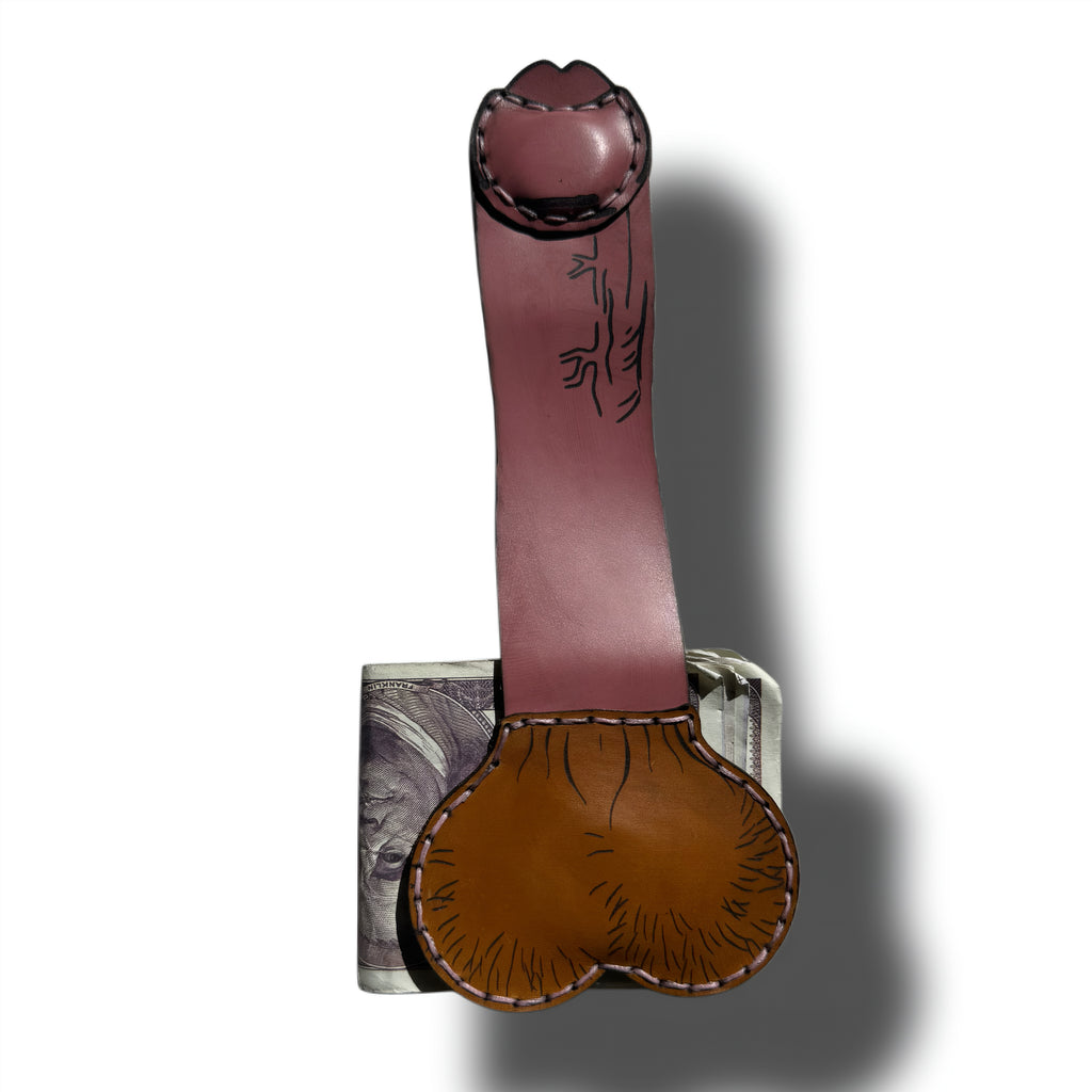 Full length view of the uncut edition XL leather money clip clipped onto a hundred dollar bill